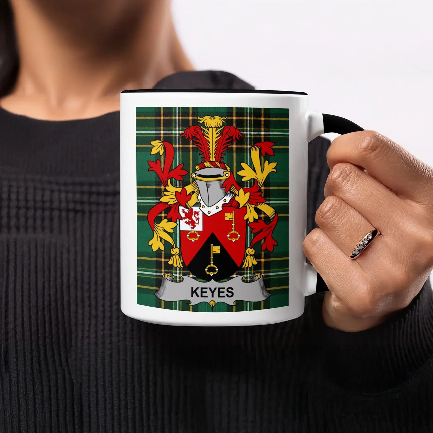 Black mug with a tartan plaid background featuring the Keyes family crest.