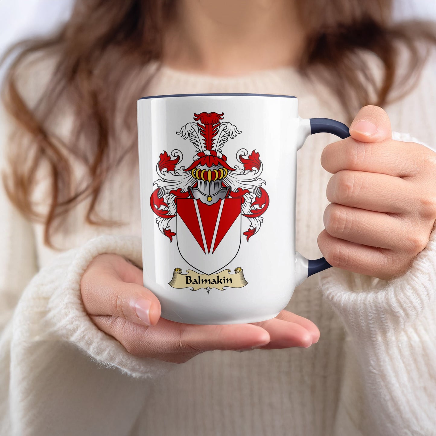 White mug with blue rim featuring a coat of arms with the name "Balmakin" on a banner.