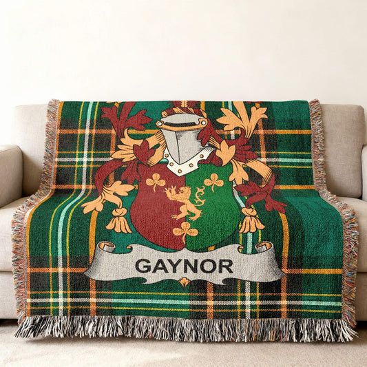 Tartan blanket with Gaynor family crest featuring shields and floral accents.