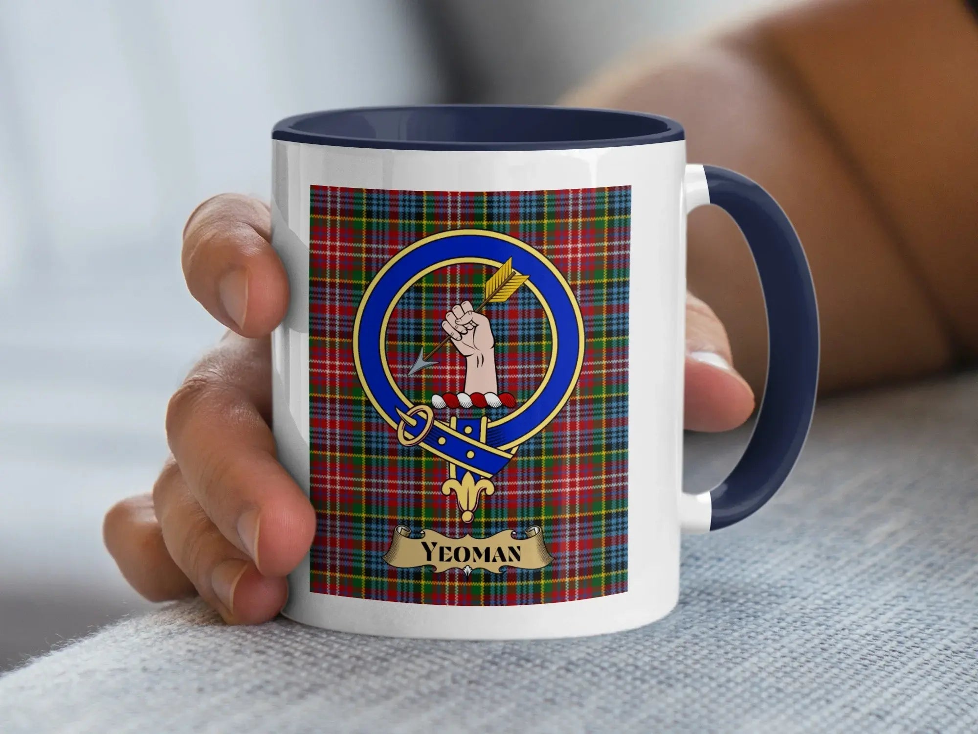 Yeoman family crest mug over a woven tartan background, a heritage gift for a Scottish status surname meaning a free landholder