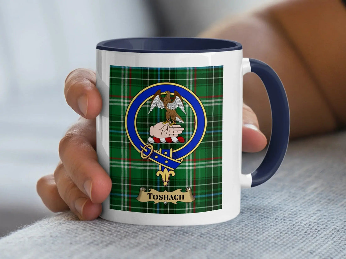 Toshach family crest mug with the crest set over a tartan background, a Scottish heritage gift for a Perthshire surname meaning chief