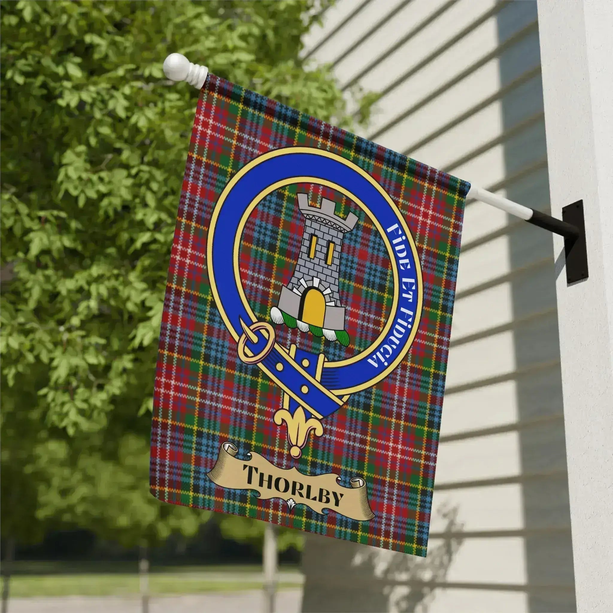 Thorlby surname crest garden flag on a woven tartan background, a heritage porch banner for a rare Yorkshire family name