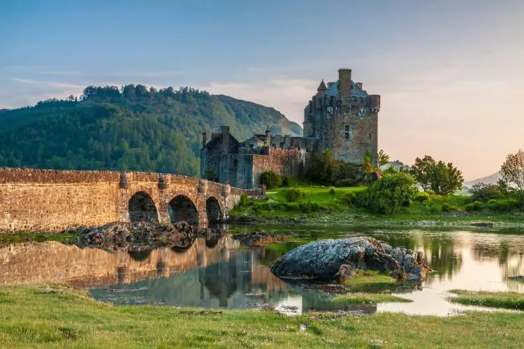 Eilean Donan Castle on the mainland route toward the Isle of Skye, surrounded by loch and mountains.