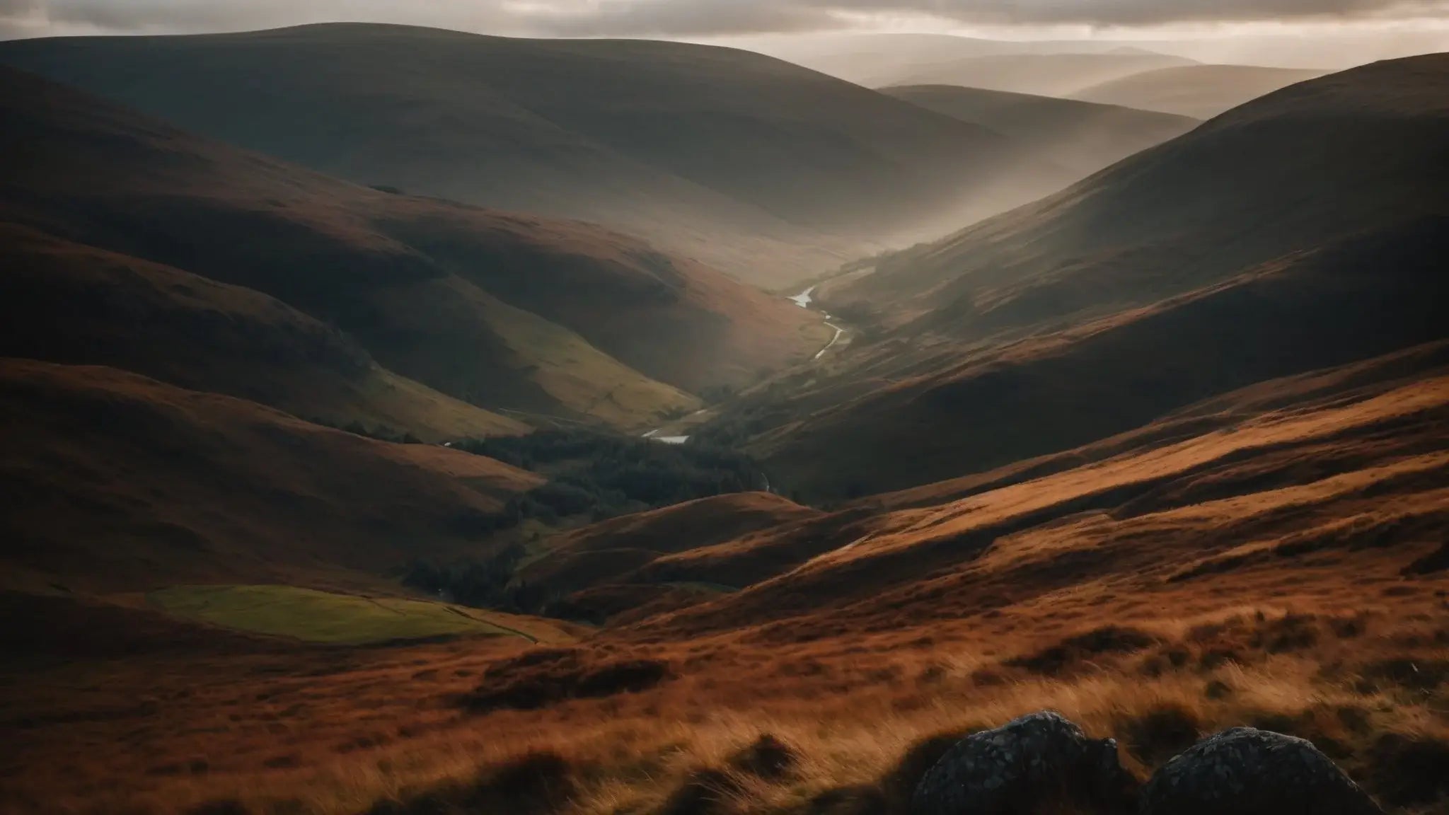 Scenic rugged Glen Shee valley in Perthshire, Scotland with rolling hills and misty sunlight