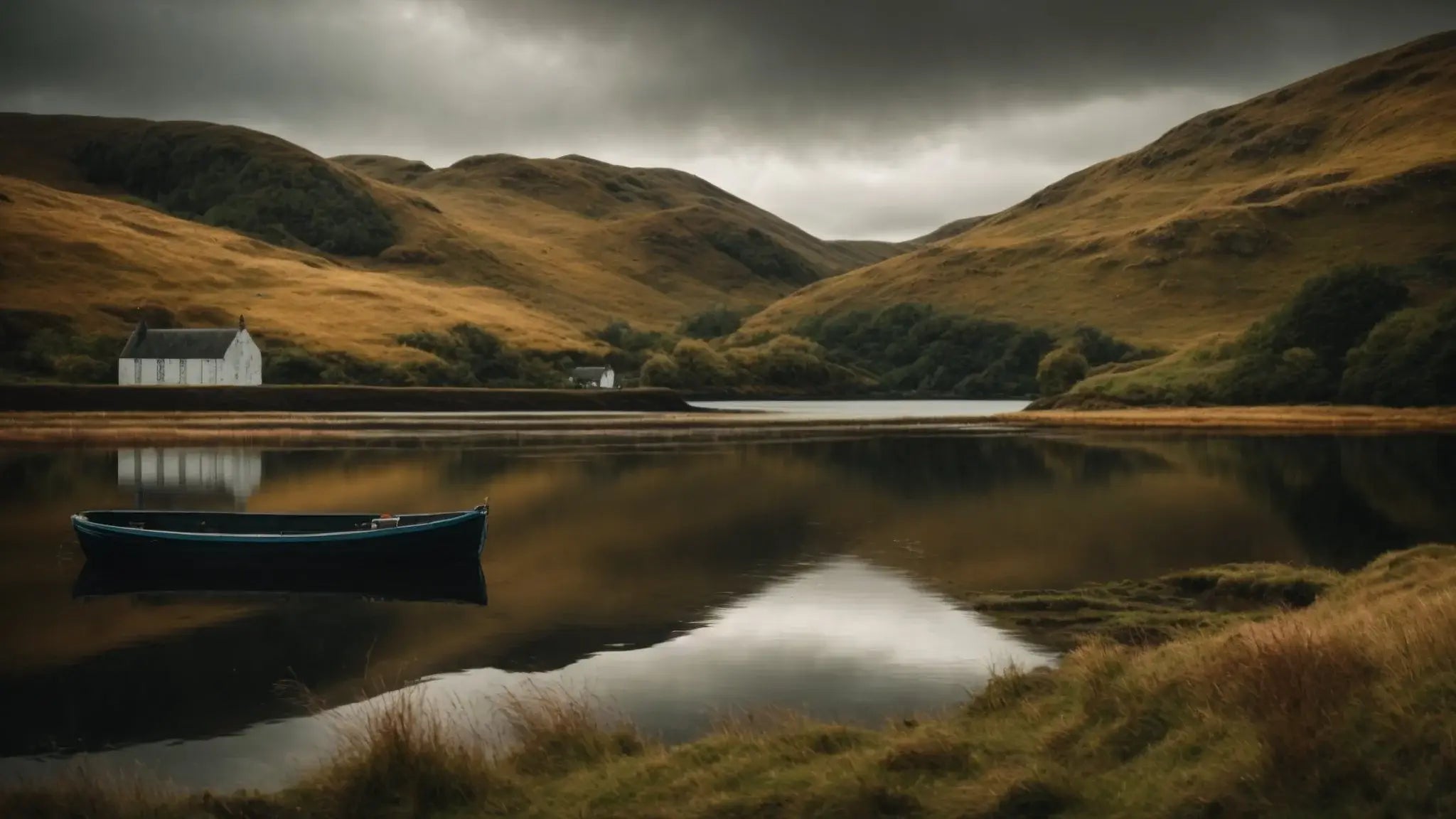 Serene Scottish canal with a lone boat, calm water reflecting hills and white cottages under moody skies