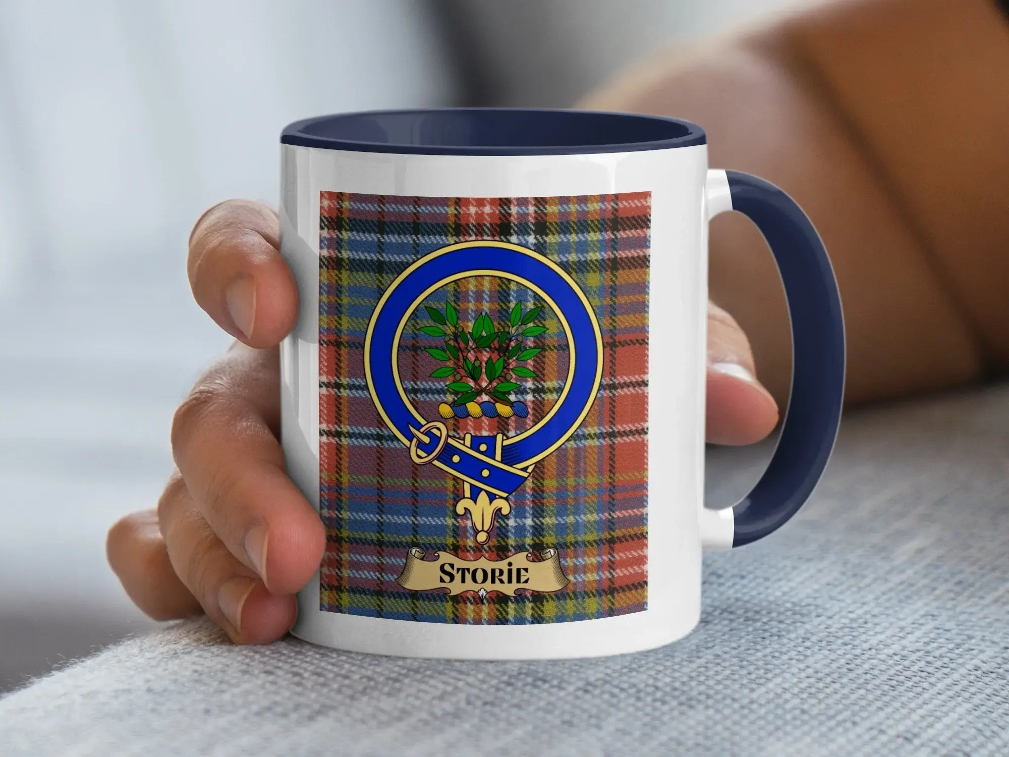 Storie family crest mug on a tartan background, a heritage gift for a Lowland Scottish surname
