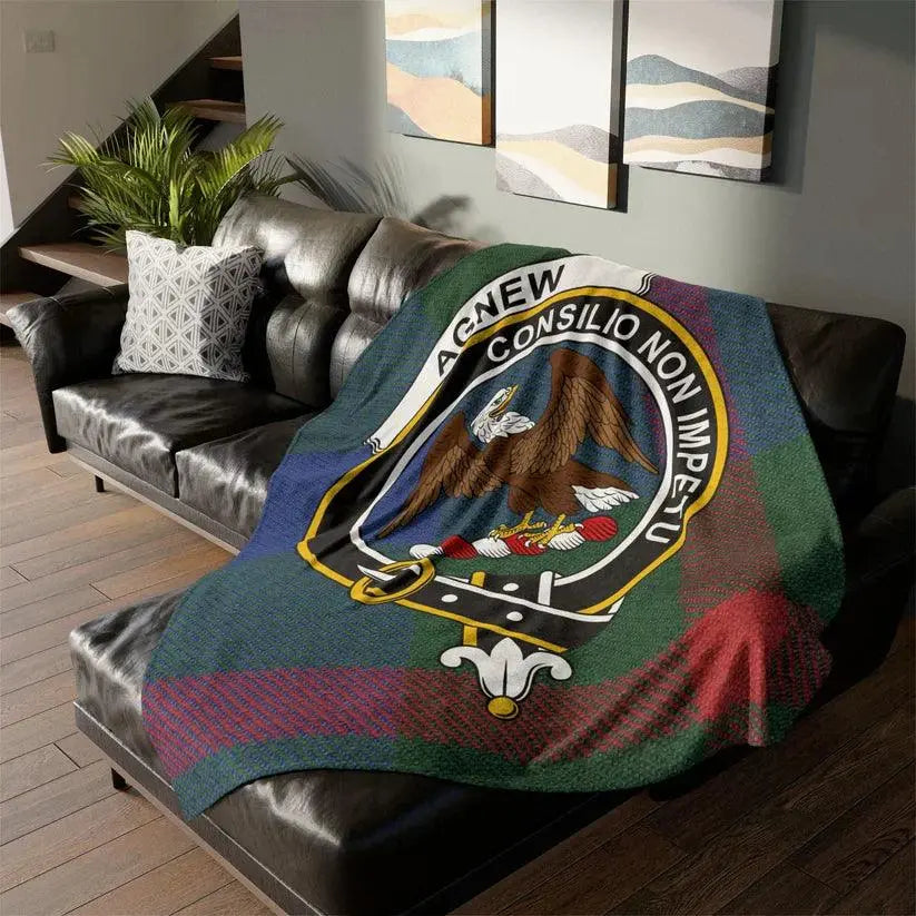 Scottish Agnew clan crest tartan throw blanket on black leather sofa in modern living room