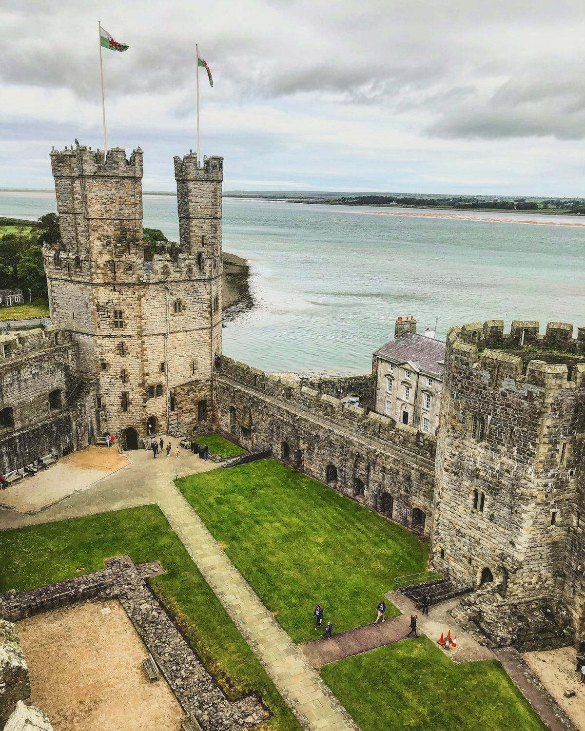 Caernarfon Castle reflected in the River Seiont at dusk, North Wales – UNESCO World Heritage Site and symbol of Welsh heritage and history