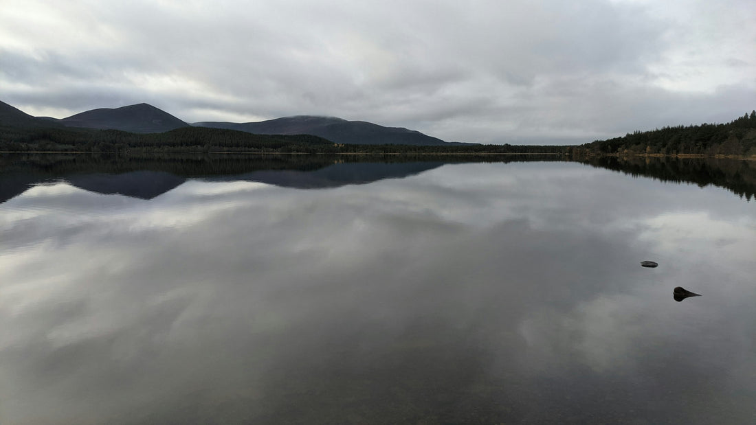 A Scottish Highlands loch ringed by mountains, evoking the homeland behind Scottish clan heritage gifts for Dad