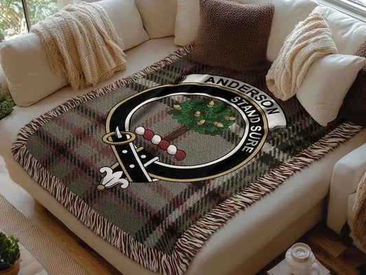Anderson clan Scottish tartan woven blanket with crest on beige couch with cushions and throws