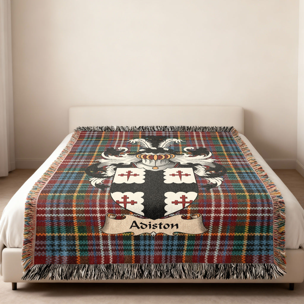 Adiston family crest emblem on a Caledonia tartan woven blanket