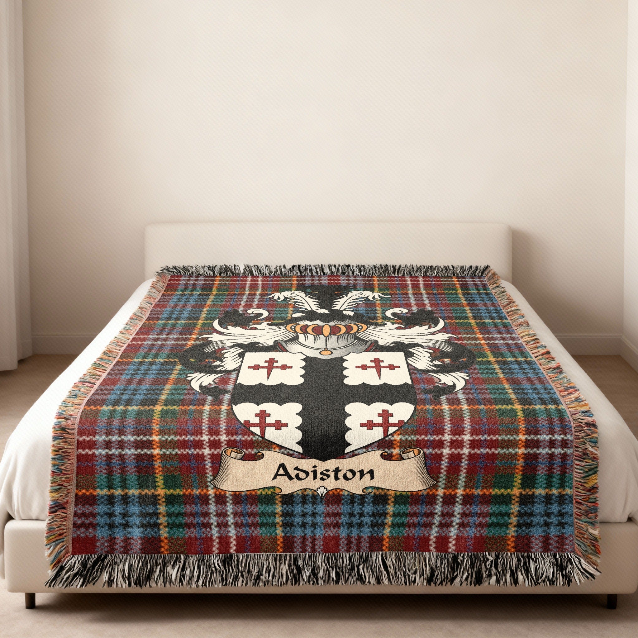 Adiston family crest emblem on a Caledonia tartan woven blanket