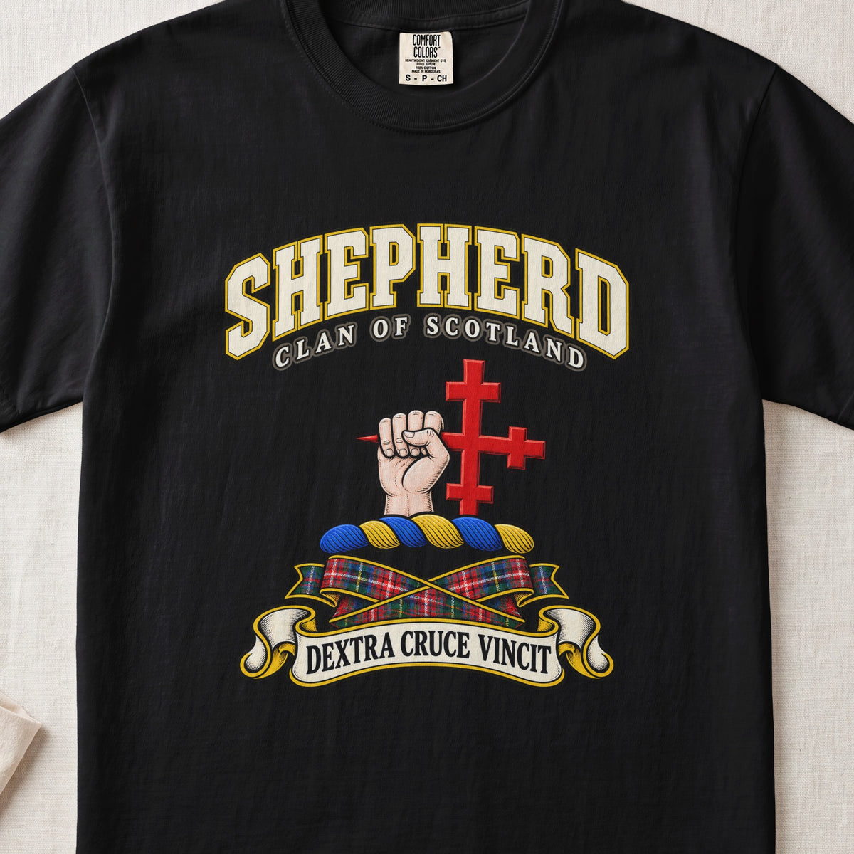 Shepherd Scottish clan T-shirt in Black, front view with a hand holding a red cross and motto banner.