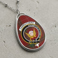 Carruthers clan Scottish tartan necklace with clan crest and Promptus et Fidelis motto on tartan background
