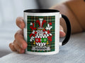 Mug with Atkinson family crest on green plaid background.