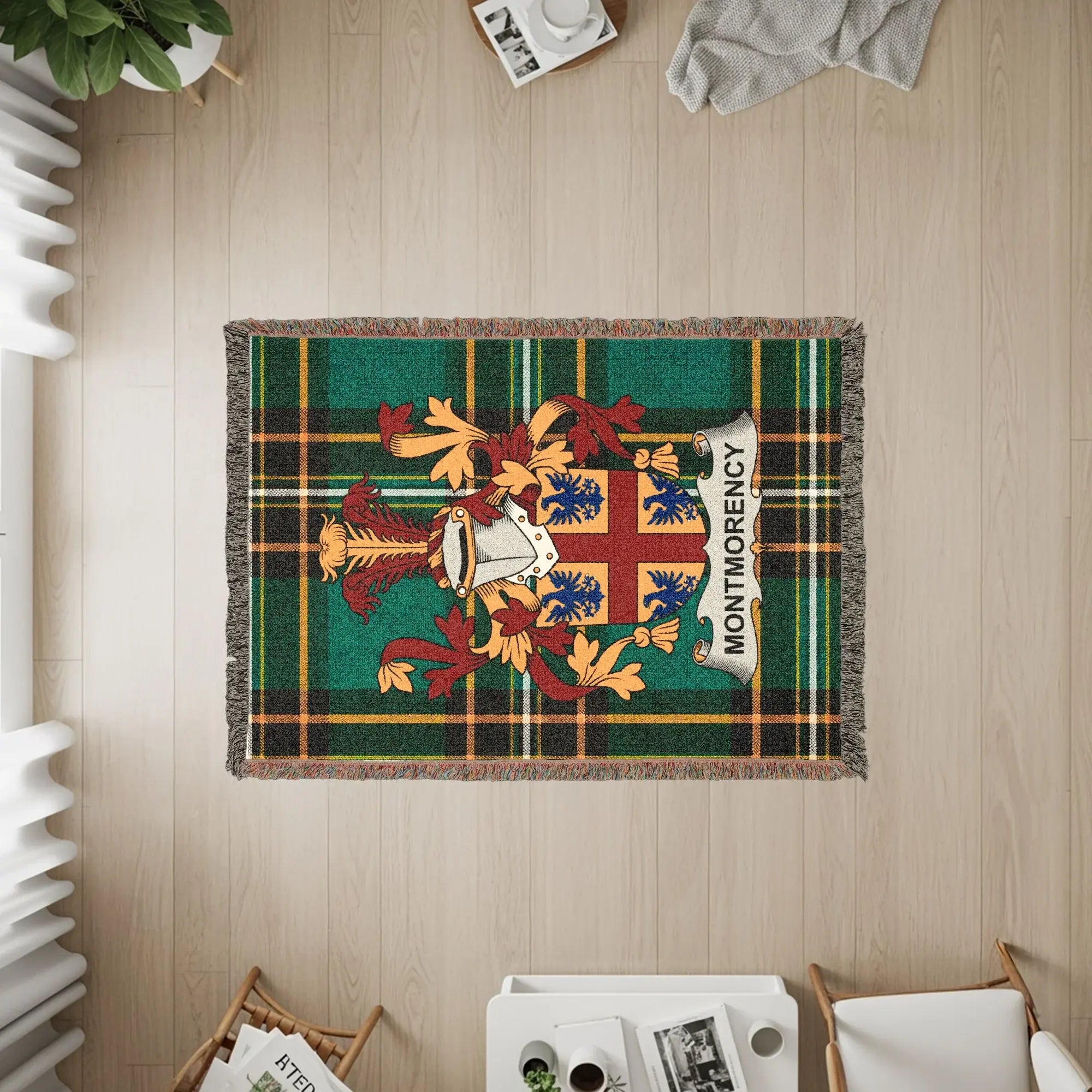 Green plaid throw blanket with Montmorency family crest in the center.
