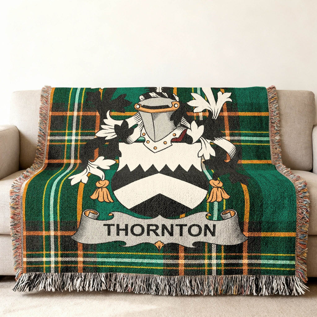 Green tartan blanket with Thornton family crest displayed.