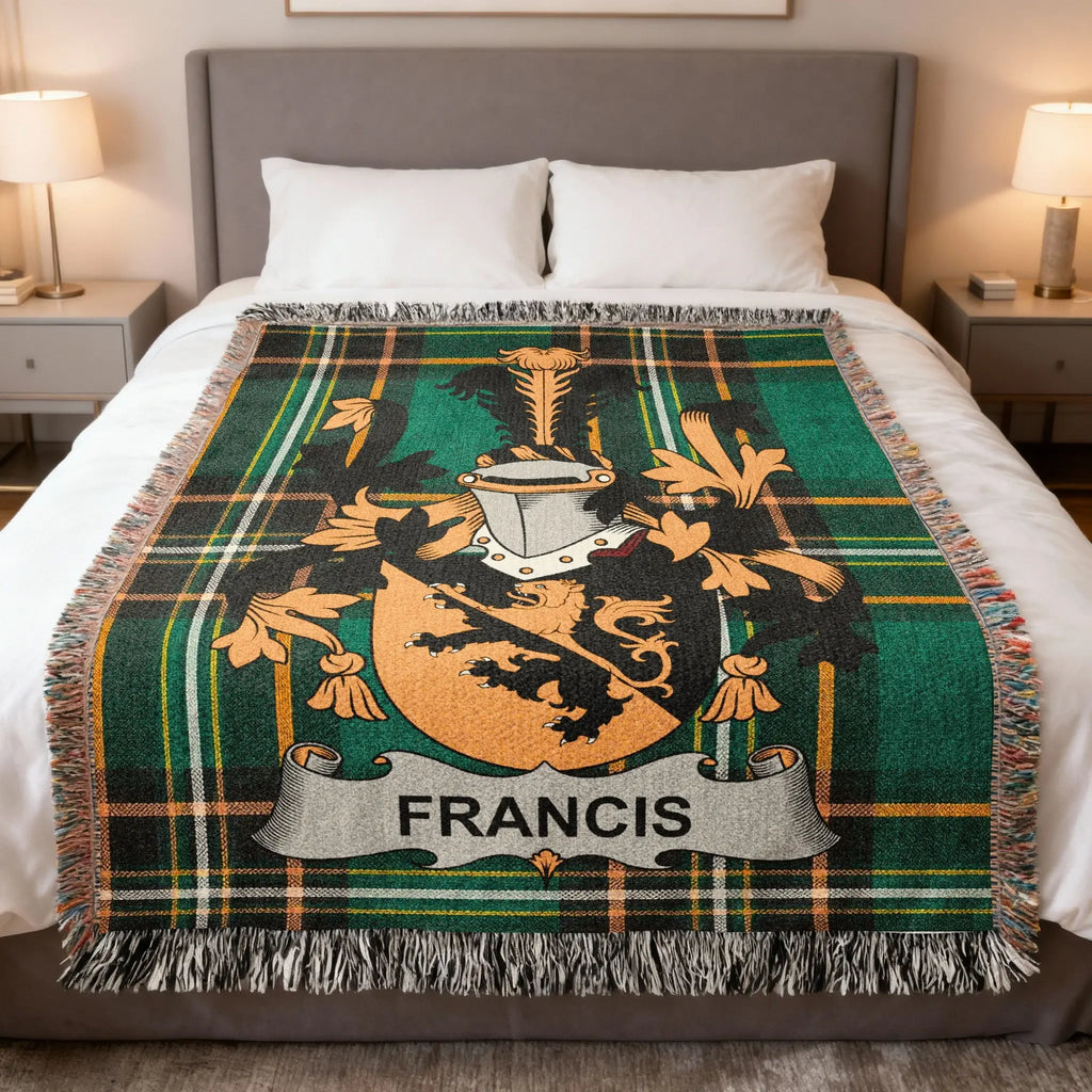 Green plaid blanket with the FRANCIS family crest on a bed.