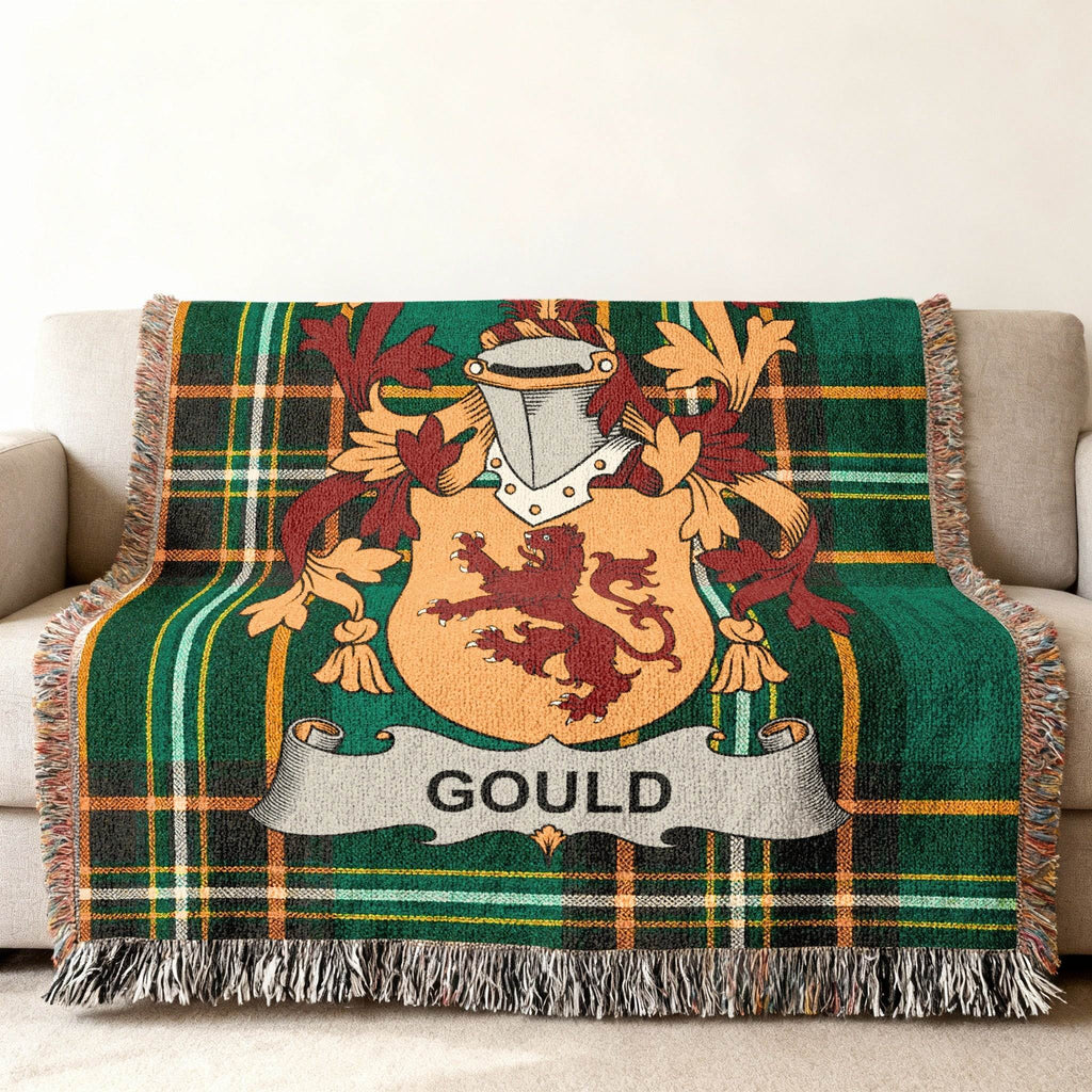 Green tartan blanket with the Gould family crest displayed prominently.