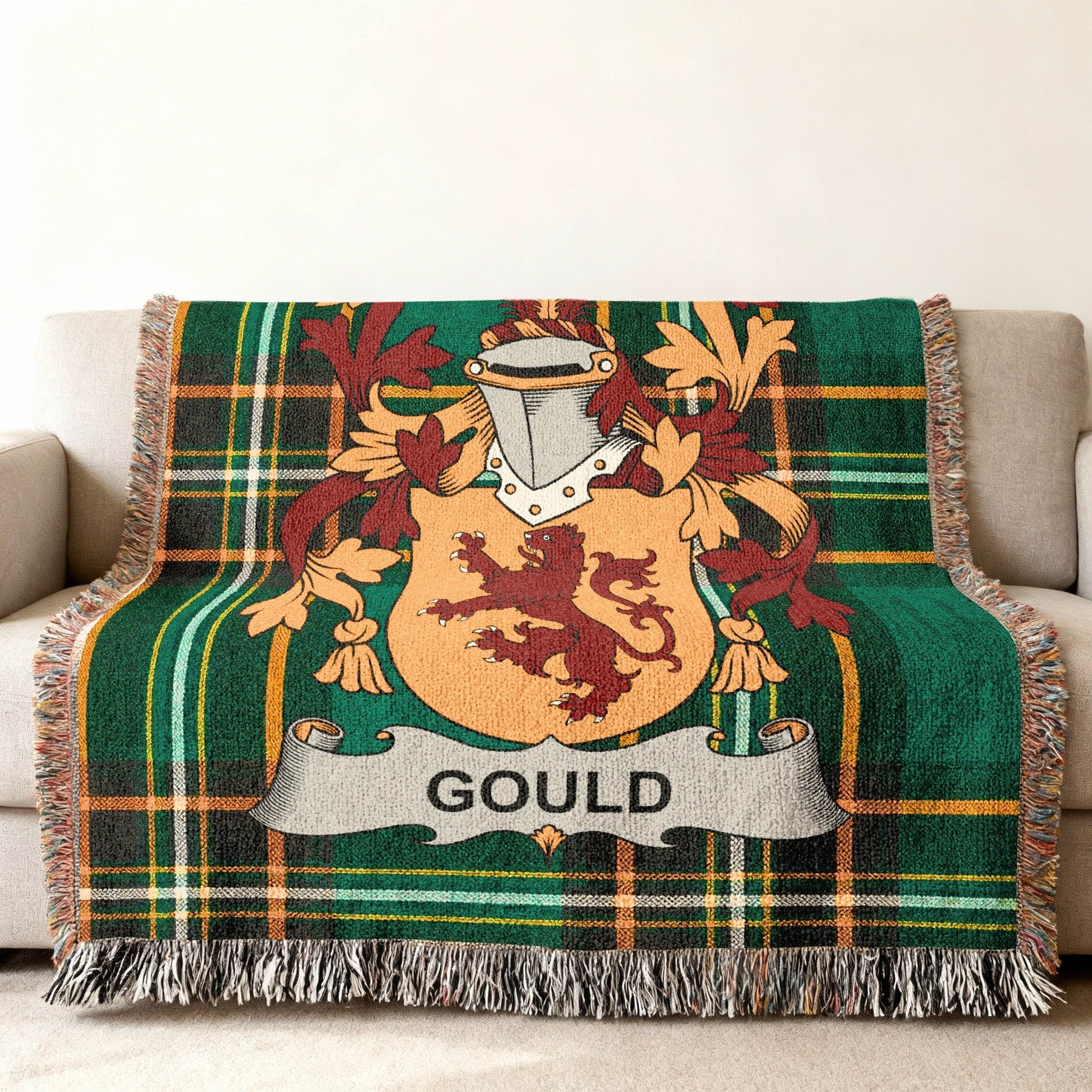 Green tartan blanket with the Gould family crest displayed prominently.