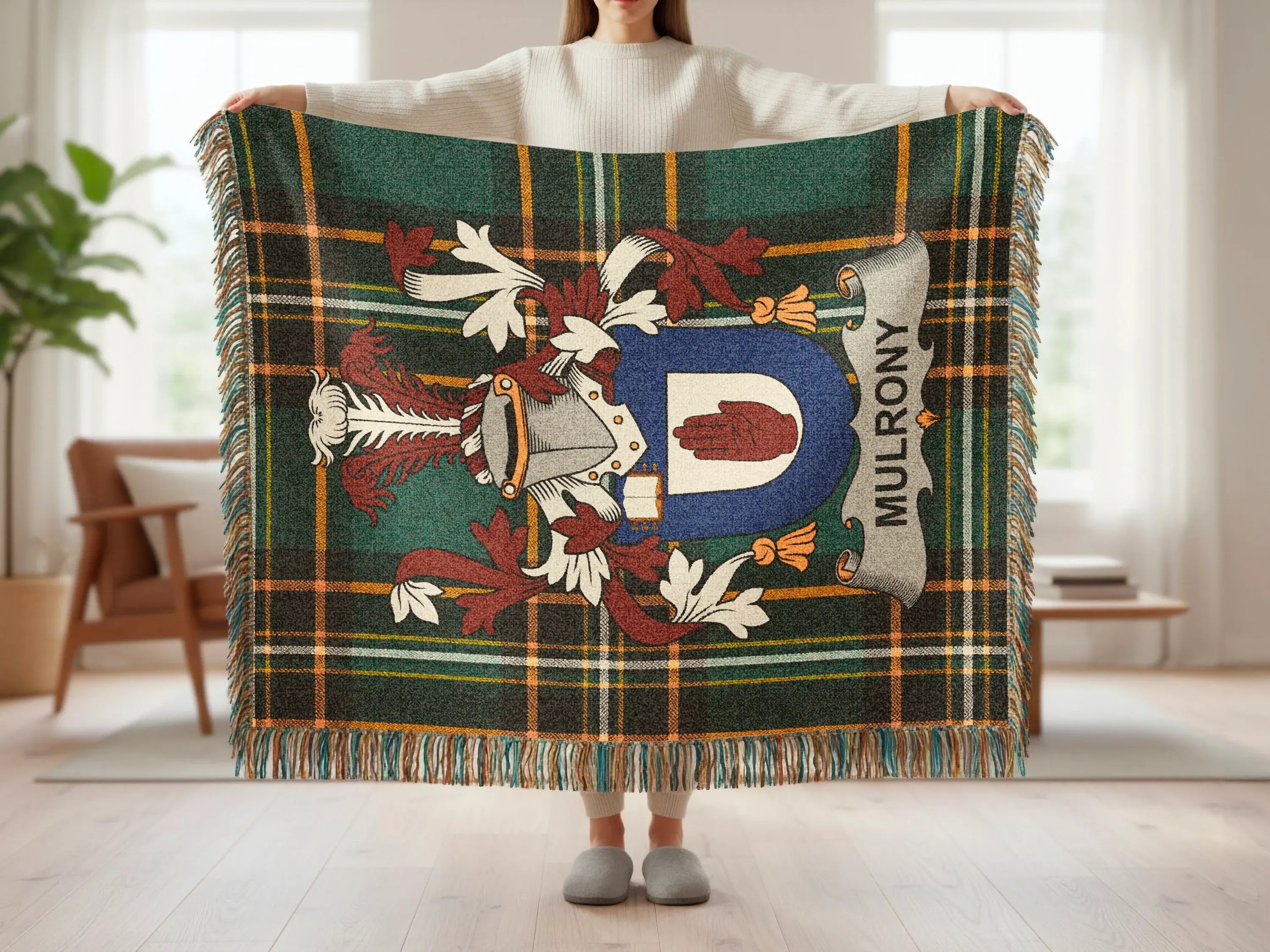 Tartan throw with family crest featuring a shield and "MULRONY" text.