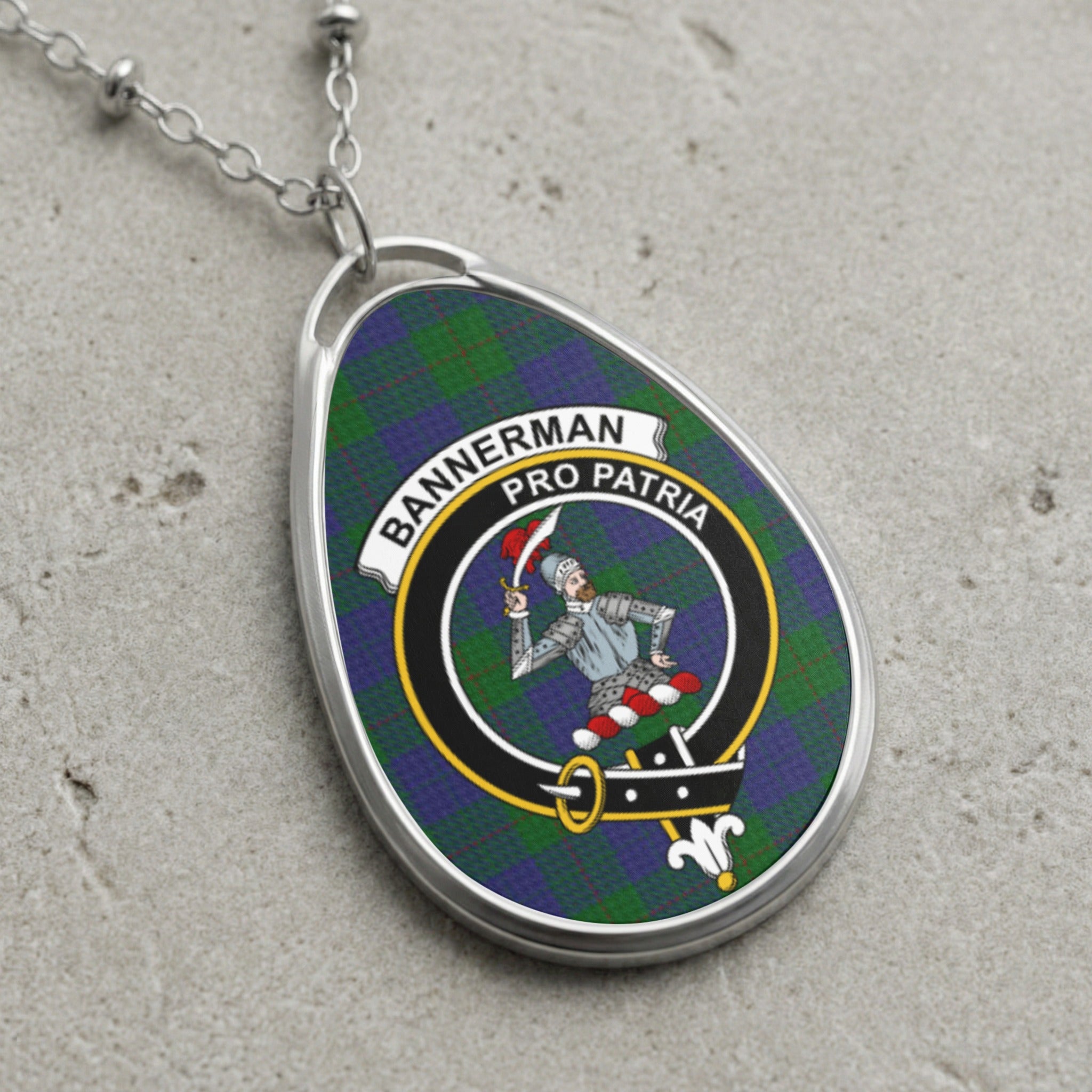 Bannerman clan Scottish tartan necklace with clan crest and Pro Patria motto on tartan background