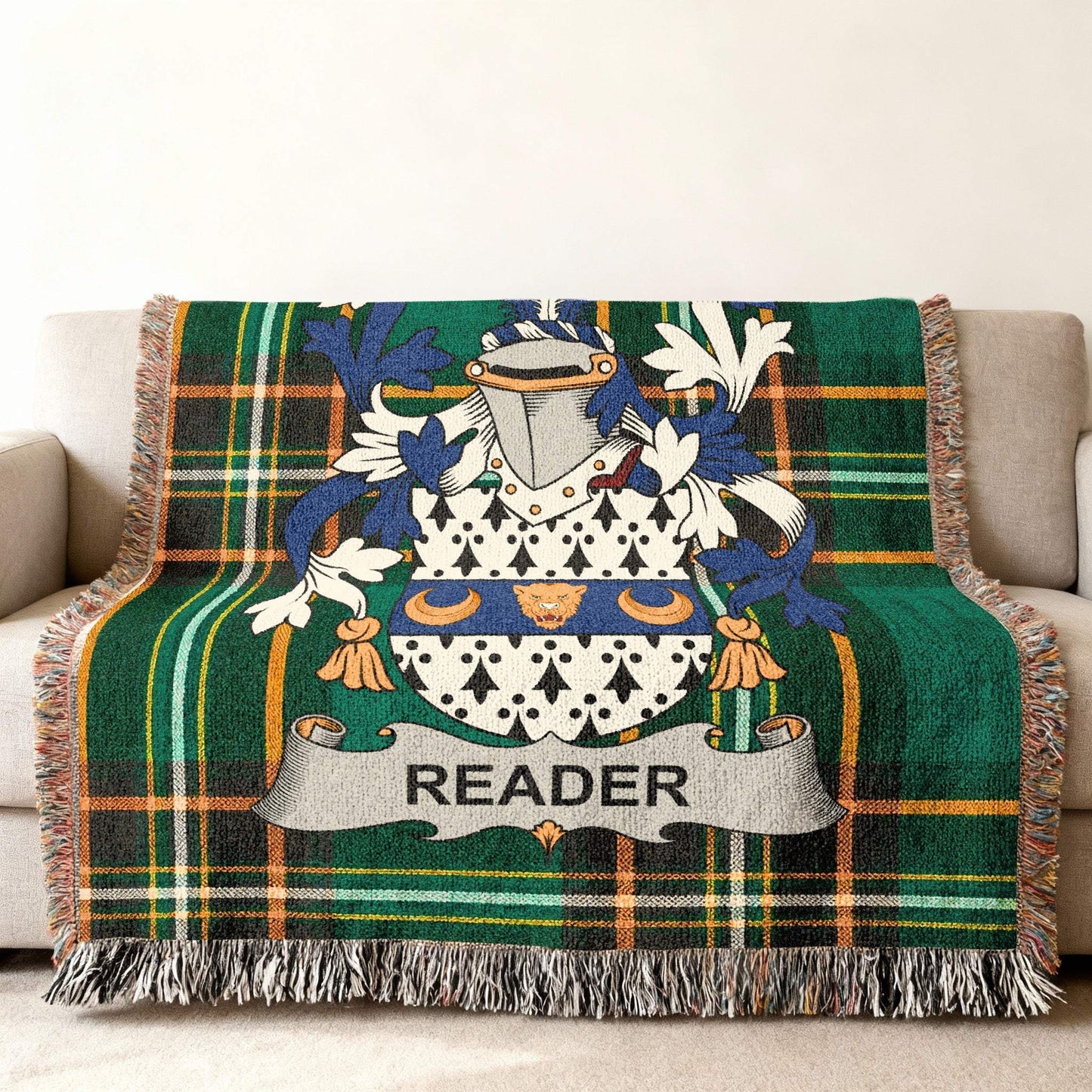 Green tartan throw blanket with family crest and "READER" banner.