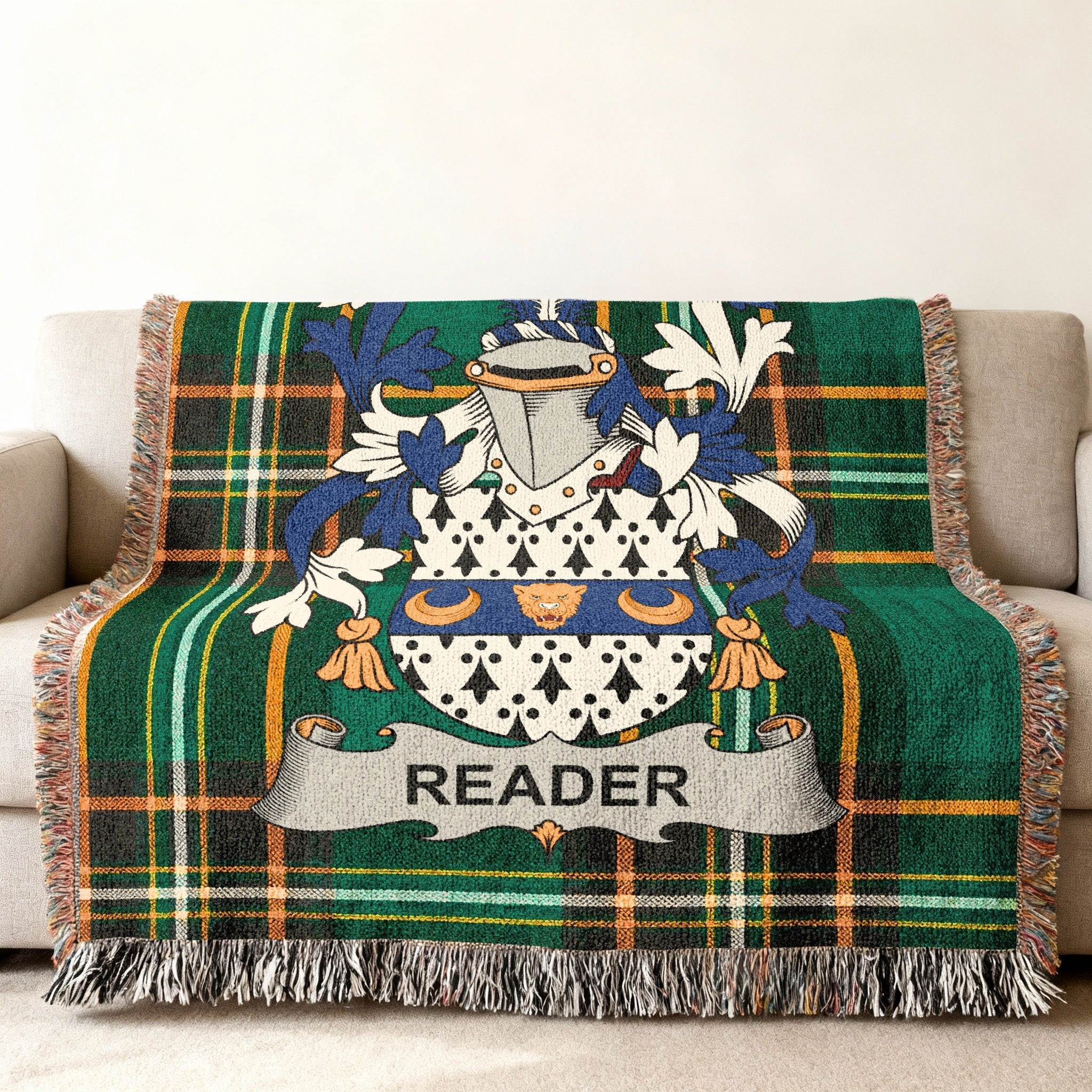 Green tartan throw blanket with family crest and "READER" banner.