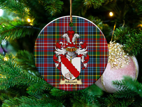 Aikman Scottish clan ceramic ornament with family crest on a Caledonia tartan background, hanging on a Christmas tree