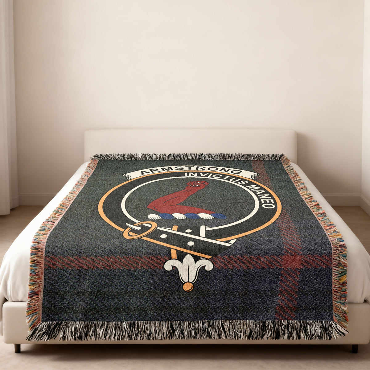 Armstrong Scottish woven blanket spread across a bed, showing the full crest design and tartan background