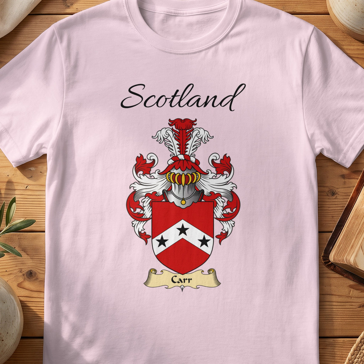 Light Pink Carr Scottish family shield T-shirt featuring a white chevron carrying black stars on red