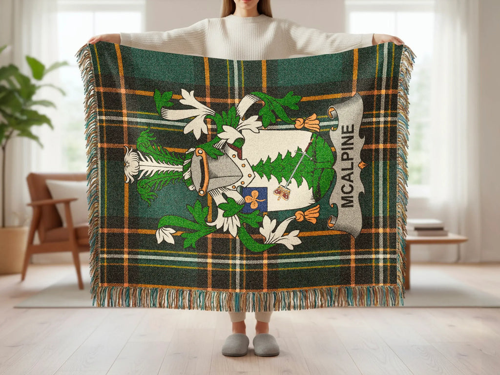McAlpine tartan blanket with crest, held by a person.
