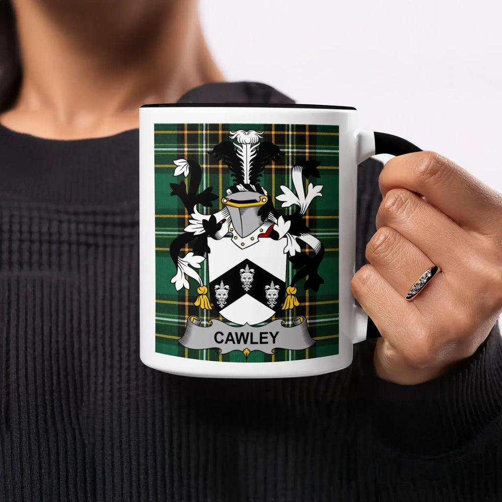 Cawley family crest on a mug held by a hand wearing a ring.