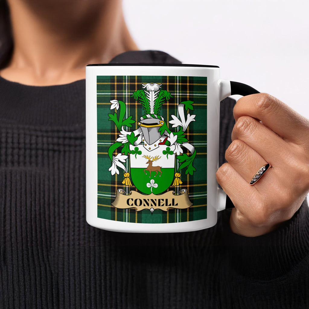 Connell Irish family crest mug on Irish National Tartan background held in hand