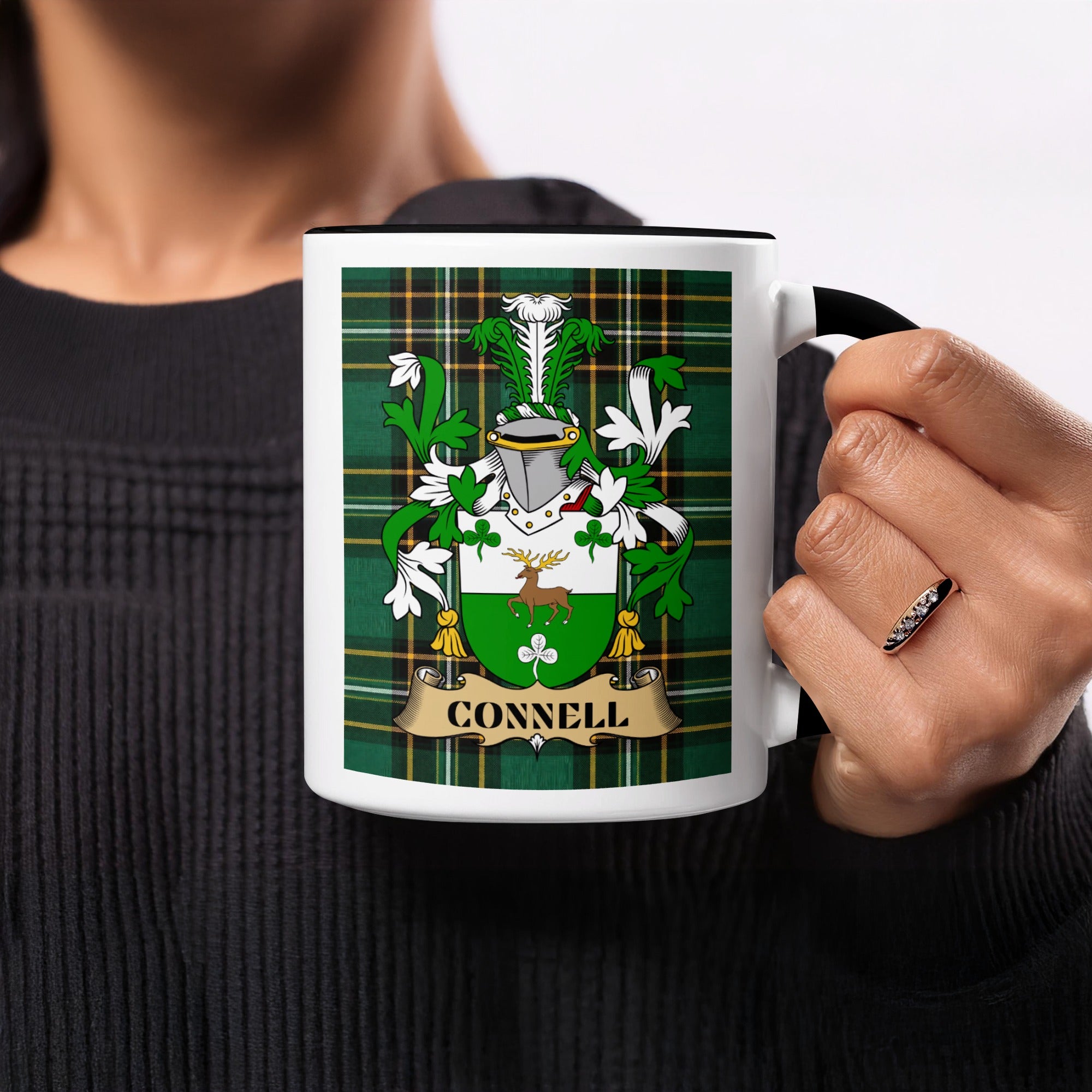 Connell Irish family crest mug on Irish National Tartan background held in hand