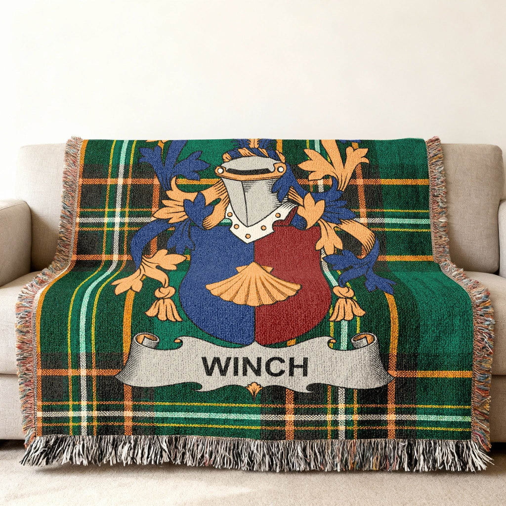 Winch family crest on a green plaid woven throw blanket.