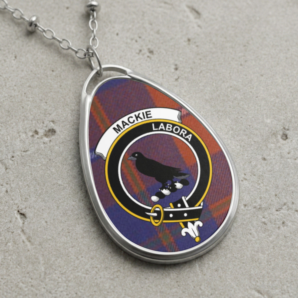 Silver chain necklace with oval pendant featuring Mackie clan crest on tartan.