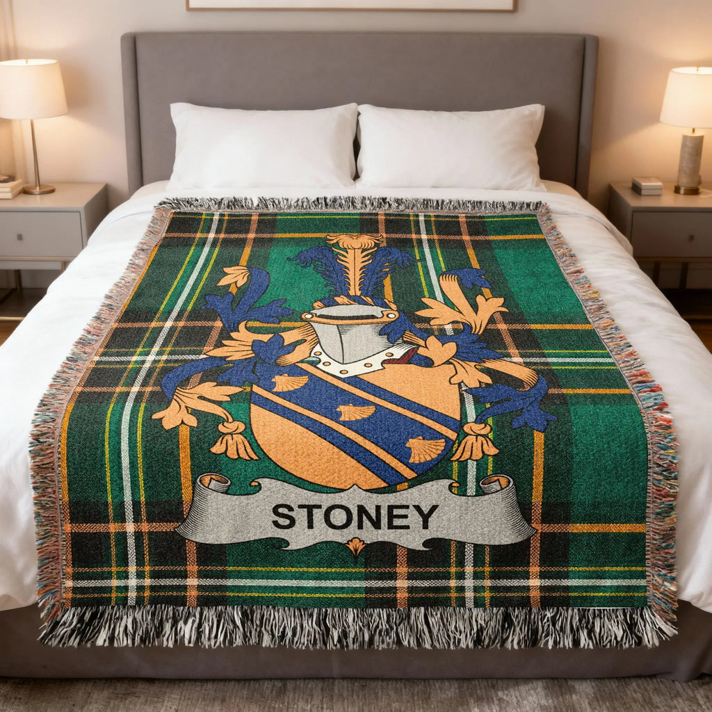 Tartan blanket with Stoney coat of arms centered on bed.