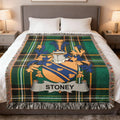 Tartan blanket with Stoney coat of arms centered on bed.