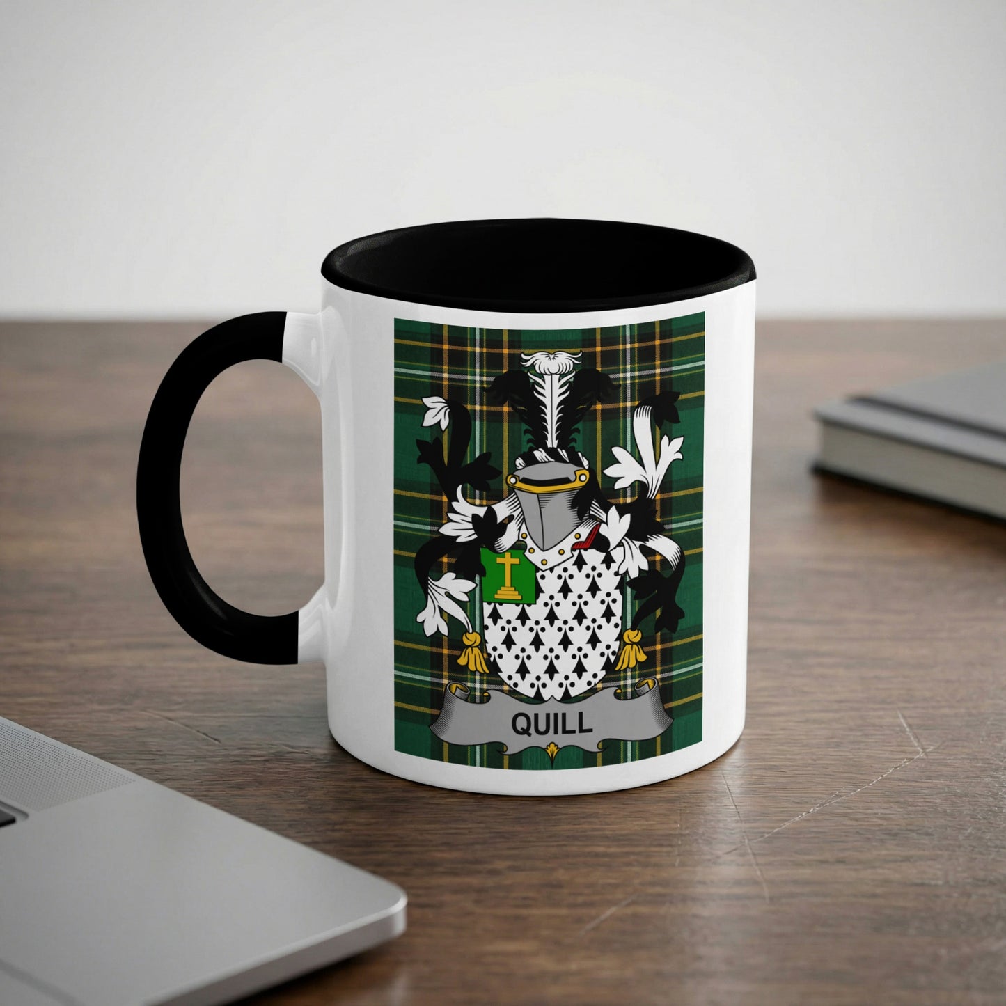 White mug with black handle and rim, featuring a green plaid background with a coat of arms.