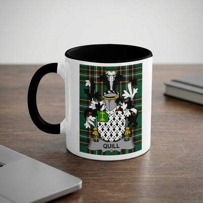 White mug with black handle and rim, featuring a green plaid background with a coat of arms.