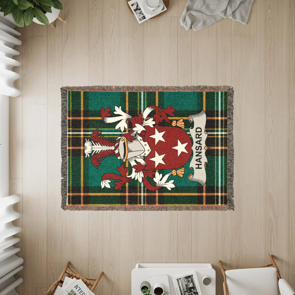 Woven blanket featuring the Hansard family crest on a green tartan background.