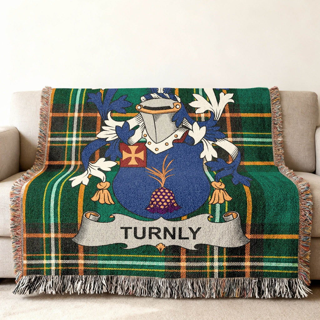 Woven plaid throw blanket with a blue and white family crest featuring the name "TURNLY".