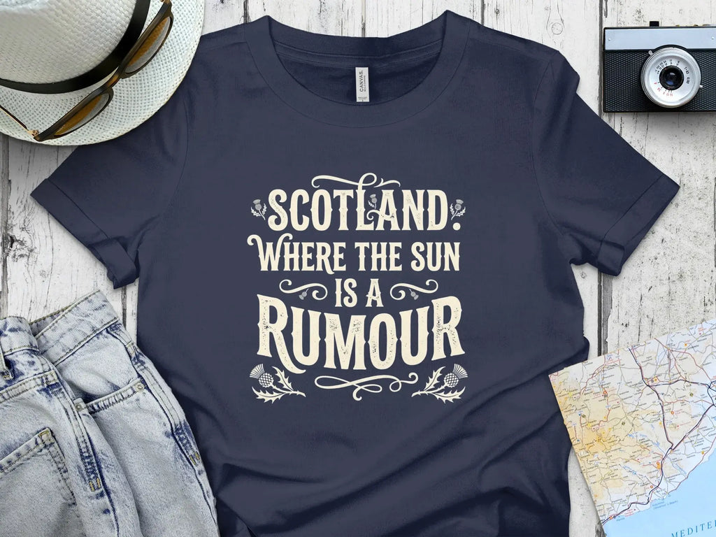 Navy t-shirt with "Scotland, Where the Sun is a Rumour" text and thistle designs.