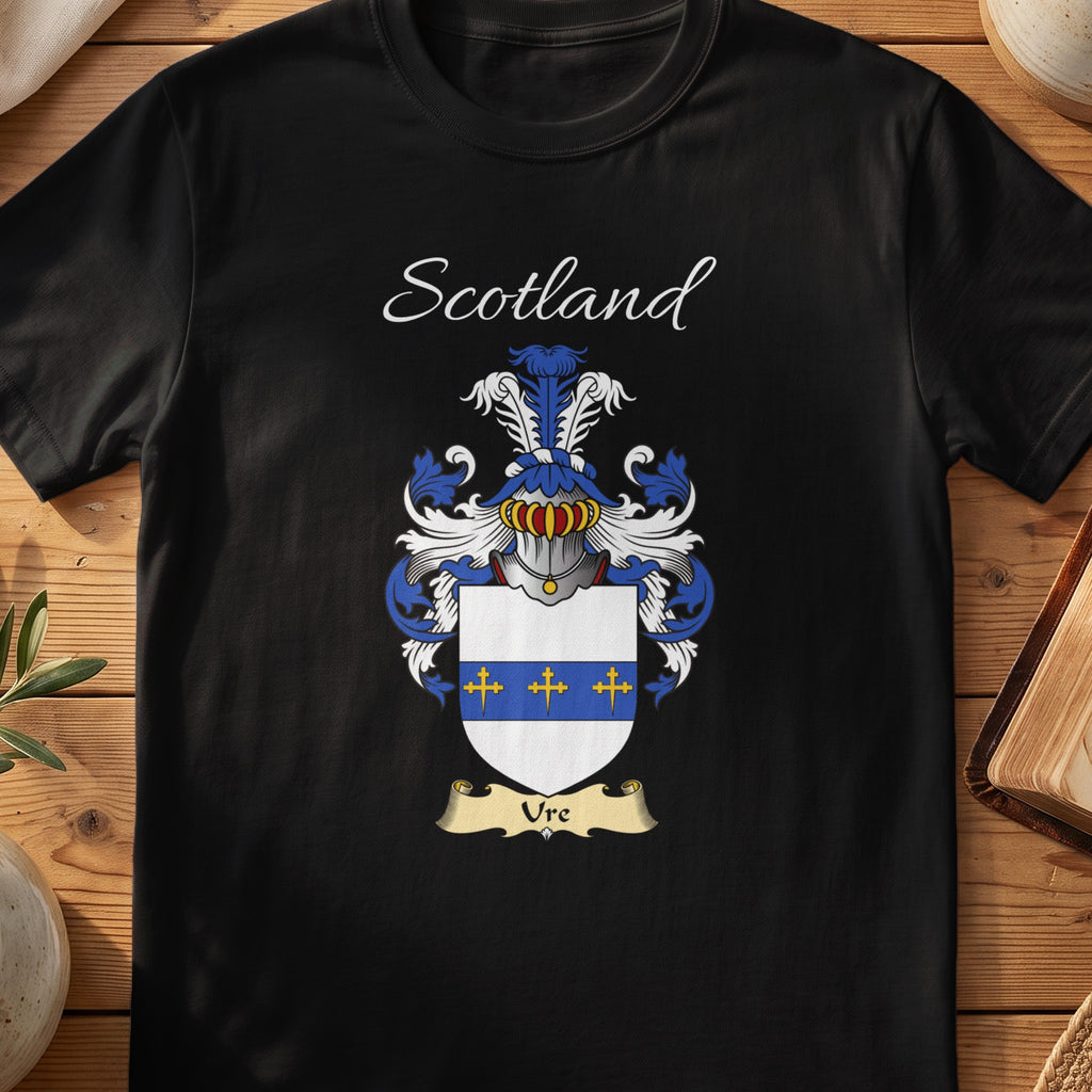 Black Ure Scottish family crest T-shirt laid flat, showing “Scotland” above a blue-and-silver shield marked by a gold horizontal band and small crosses.