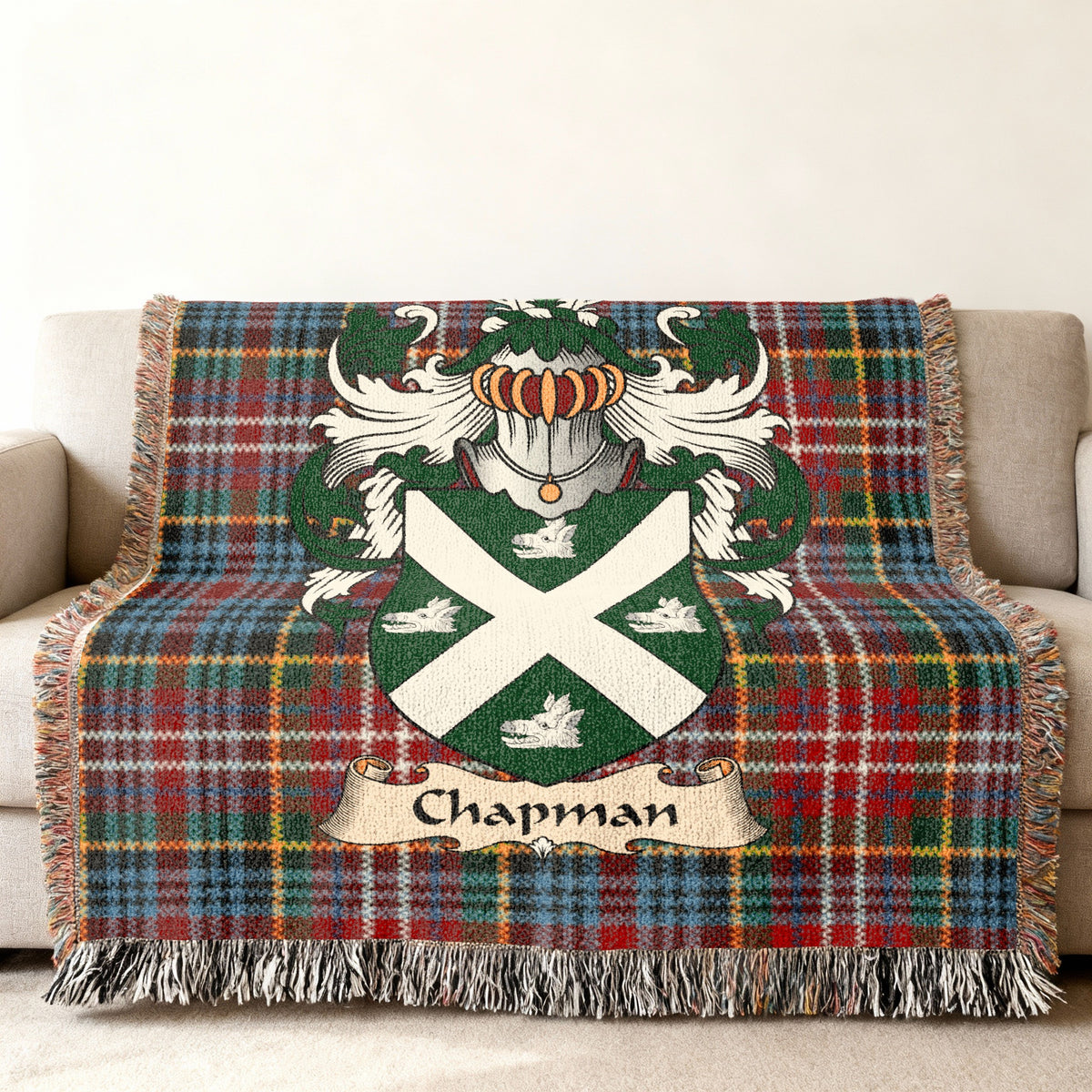 Chapman family crest emblem on a Caledonia tartan woven blanket