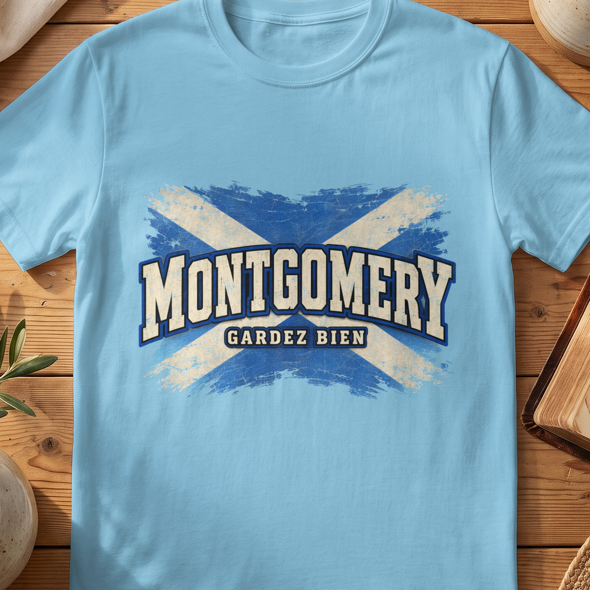 Montgomery Scottish Saltire T-shirt in Sky, with distressed blue and cream flag and “Gardez Bien” lettering.