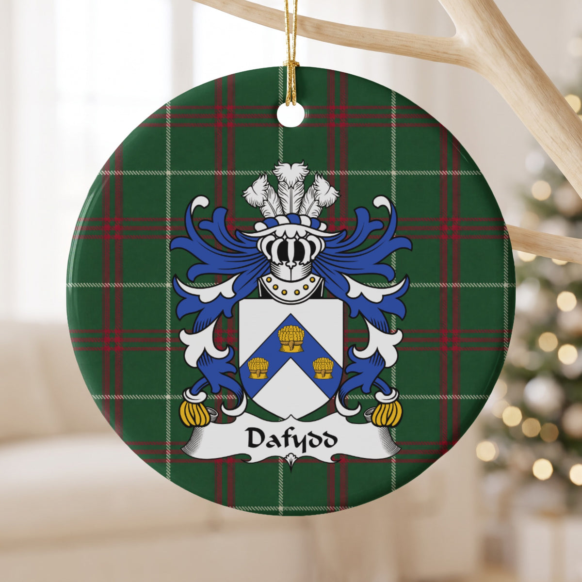 Dafydd Style 1 ornament hanging from a pale wooden branch; a blue chevron bearing three gold wheatsheaves on a white shield on Welsh national tartan.