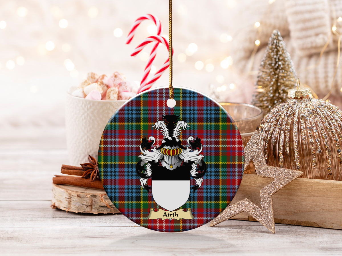 Airth family emblem ceramic Christmas ornament with Caledonia tartan background in festive holiday décor