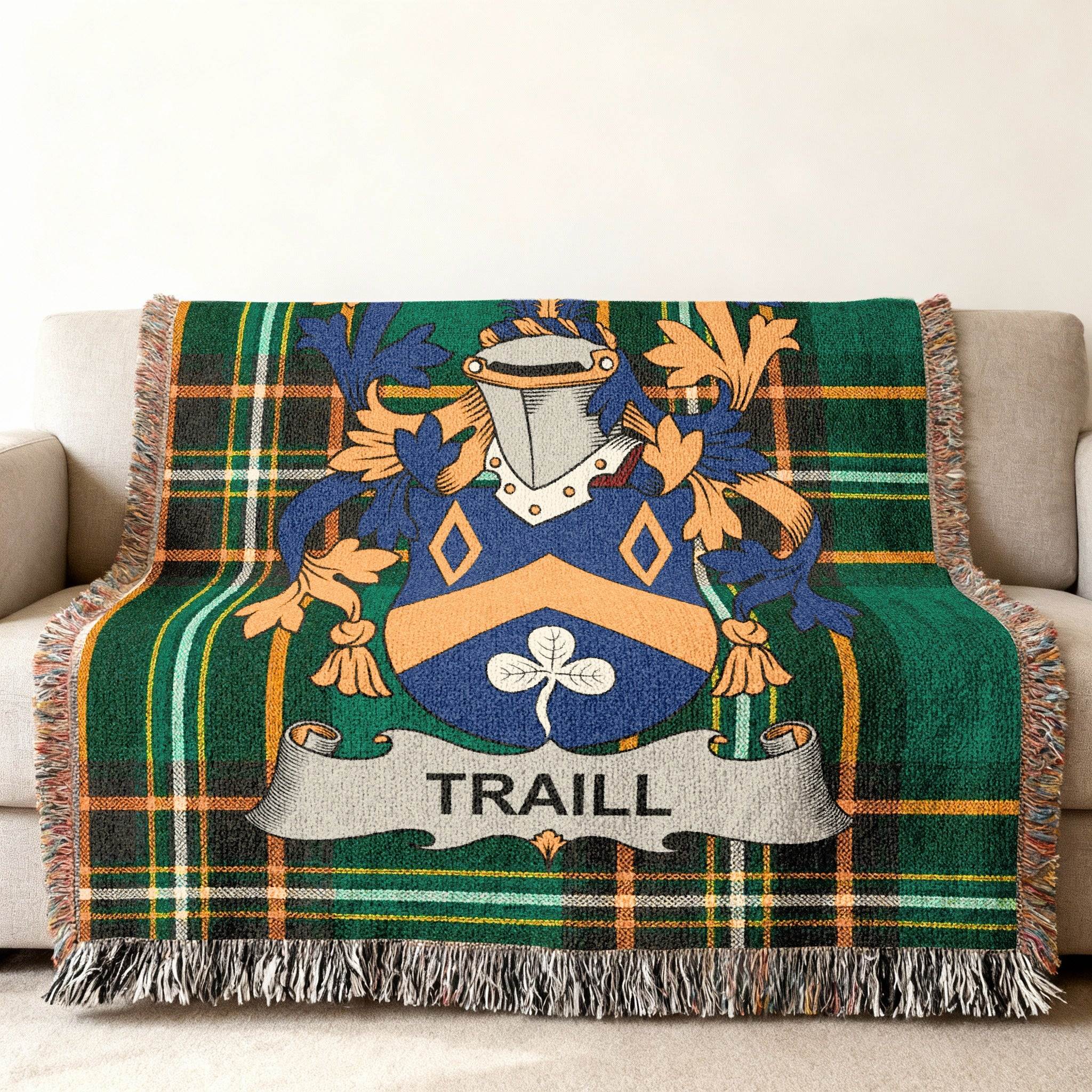 Tartan blanket with a blue and gold crest bearing the name TRAILL.